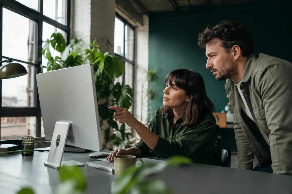 Editorial team reviewing digital research in an Australian warehouse studio